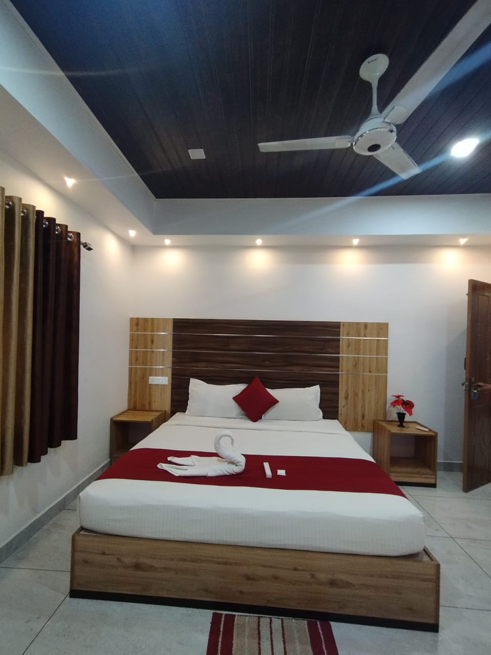 Deluxe room with dark wood ceiling and swan towel art