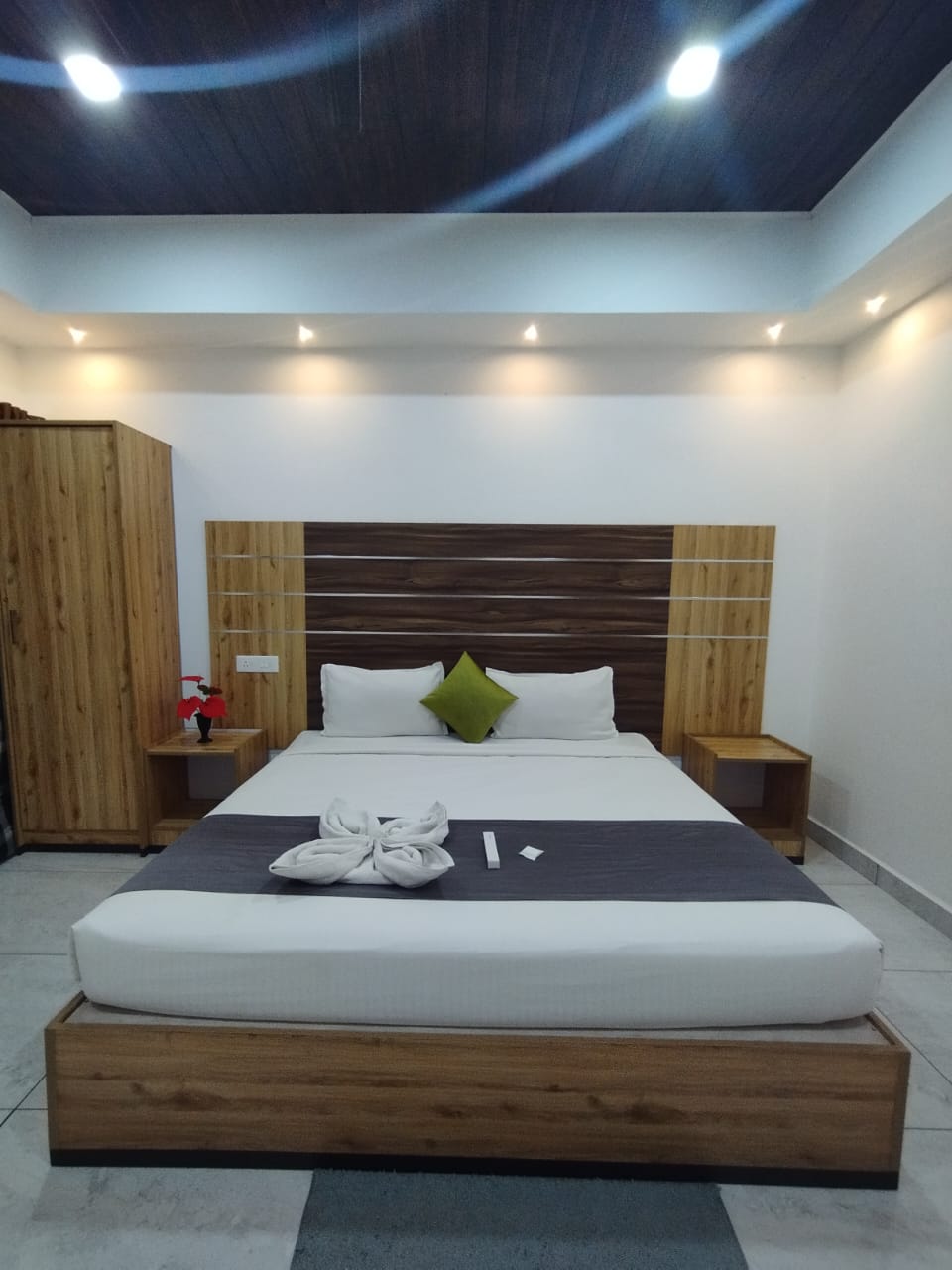 Room with green cushion and swan towel art